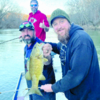 Guide Tommy Bench holds Nathan "Shags" McLeod's Gasconade River dinosaur, with Adam Voight admiring the catch.